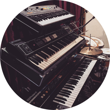 More synthesizers stacked in the recording room